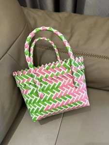 Detail of pink and green handwoven mesh pattern on a durable tote gift bag