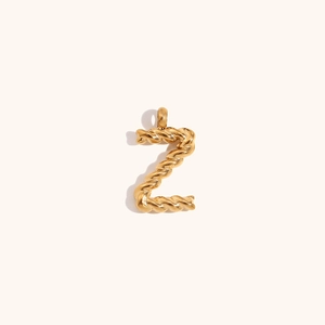 Macro shot of gold-plated twisted rope texture on the letter Z pendant accessory