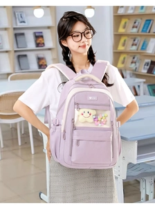 Detail view of purple school backpack with transparent window and plush star decorations