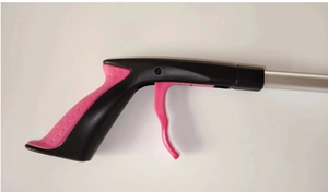 Close-up of pink and black ergonomic trigger handle for folding grabber reacher tool