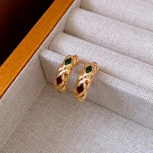 Vintage gold C-shaped hoop earrings with textured diamond pattern and colorful gemstones