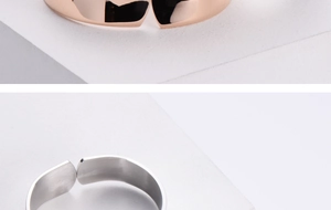 Macro detail of high-polished minimalist bangle set in rose gold and silver finish