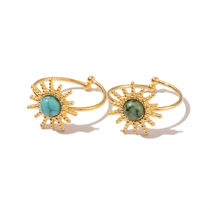 Gold sunburst open rings set with turquoise and green stone on white background