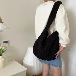 Detail of black popcorn texture tote bag with large capacity shown in a lifestyle setting