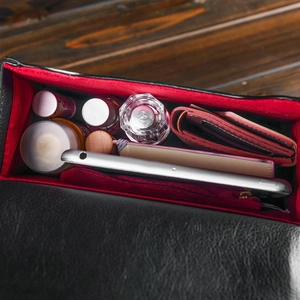 Top-down view showing red fabric lining and large capacity of the clock-shaped crossbody bag