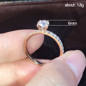 Minimalist cubic zirconia engagement ring in rose gold with 6mm center stone and pavé band