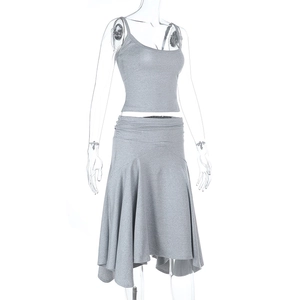 Detail view of grey two-piece set featuring a one-shoulder crop top and ruffled skirt