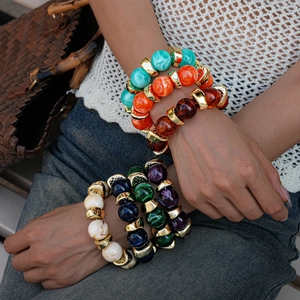 Detailed macro shot of bohemian multilayer beaded bracelets with colorful marble textures