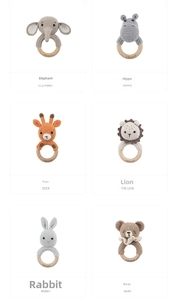 Macro view of six animal crochet baby rattles with engraved I Love Mom wooden rings