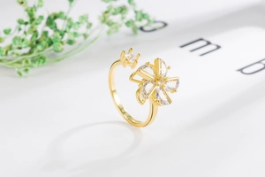 Close-up of golden windmill ring with cubic zirconia showing size measurement on a ruler