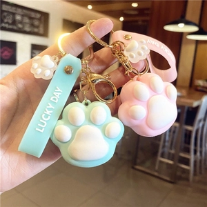 Cute cartoon cat paw silicone keychains in pink and blue with Lucky Day strap