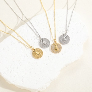14K gold plated necklace with holding hands pendant and zircon stones on a stone background