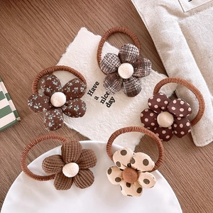 Set of five floral hair ties in brown shades featuring checkered and polka dot patterns