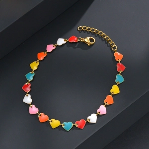Detail of colorful enamel heart charms on a gold-plated link bracelet with lobster clasp