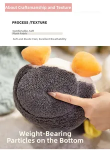 Close-up of plush penguin toy fabric showing the soft texture and weighted base particles