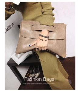 Macro shot of large capacity taupe PU leather envelope clutch bag with handle detail