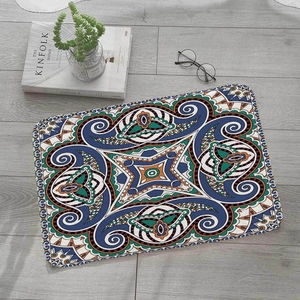 Detail of bohemian paisley flannel floor mat on light wood floor with home decor props