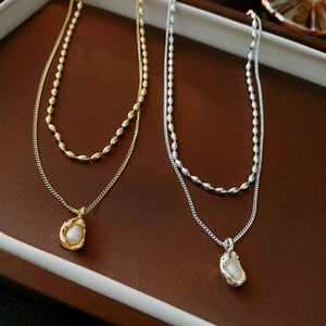 Double layered French vintage necklace set with baroque pearl pendants in gold and silver