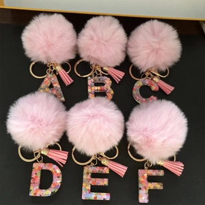 Pink fluffy pom pom alphabet keychains with colorful resin glitter letters A to F