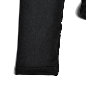 Detail view of the knitted fabric sleeve with high-quality stitching on a black bodysuit