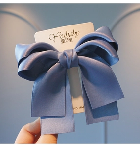 Detailed view of mist blue satin double-layer bow hairclip with premium silk texture