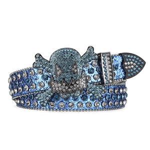 Detailed view of shimmering blue rhinestones and skull buckle on a punk hip-hop style belt