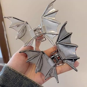 Gothic bat-shaped metal hair claws in silver and gunmetal grey for Halloween styling