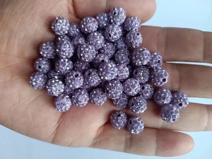 Close-up of 8mm purple clay disco ball beads with sparkling rhinestones for DIY jewelry