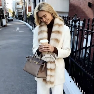 Women's white mid-length wool coat featuring a large faux fur collar for autumn fashion