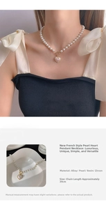 Detail of pearl heart necklace featuring a toggle clasp and iridescent pendant charm