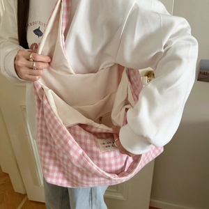 Detail of pink plaid canvas shoulder bag showing large interior space and inner pocket