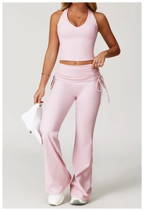 Detail of light pink yoga set featuring side drawstring flared pants and a halter vest