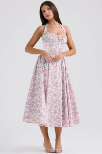 Detail of floral halter dress featuring light blue fabric with pink and purple flower prints