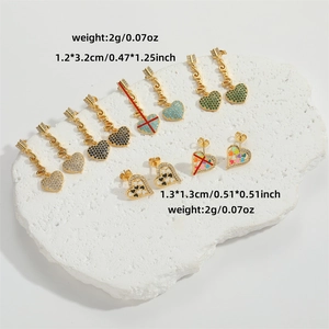 Elegant gold heart earrings set featuring colorful enamel and rhinestones on stone