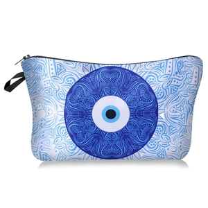 Detail of waterproof evil eye cosmetic bag featuring blue mandala print and black zipper