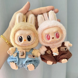 Close-up of pink and brown Labubu plush doll pendants wearing stylish overalls