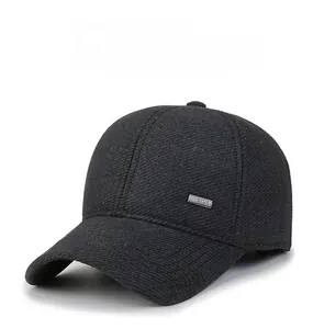 Detail of grey wool baseball cap showing twill texture and sport metal badge
