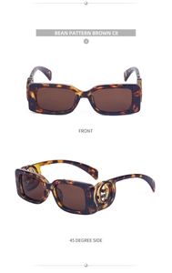 Detail of tortoise shell rectangular sunglasses with gold interlocking side ornaments