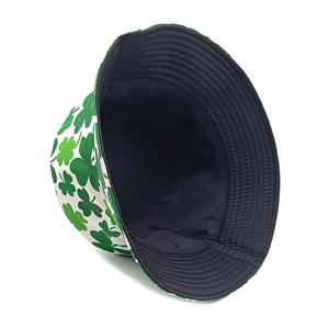 Close-up of double-sided bucket hat featuring green shamrock pattern and black inner lining