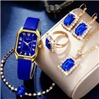 Close-up of elegant women's quartz watch set with blue stones and gold metal jewelry
