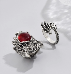 Detailed close-up of vintage silver dragon ring featuring a bold red gemstone and ornate scales