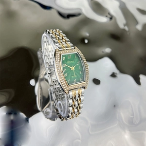 Women's emerald green dial quartz watch with tonneau gold-silver case and crystal bezel