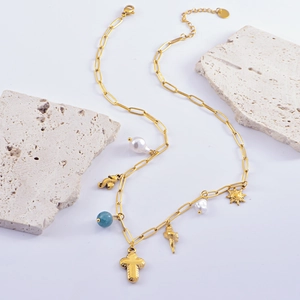 Gold paperclip chain necklace with sea charms, cross pendant and baroque pearl accents