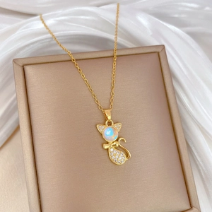 Elegant gold cat pendant necklace with white zircon and crystals on a silk background