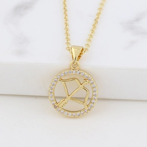 Macro shot of gold Sagittarius pendant featuring archer motif and sparkling crystals