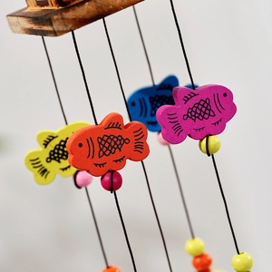 Colorful wooden fish wind chime with vibrant yellow blue and red hanging ornaments