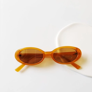 Detail view of amber orange square kids sunglasses with UV400 and CE certification labels