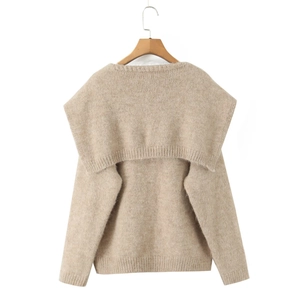 Macro detail of oatmeal chunky knit texture and sailor-style oversized shawl collar