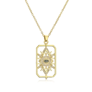 Macro view of gold plated hollow evil eye pendant necklace with blue gemstone inlay