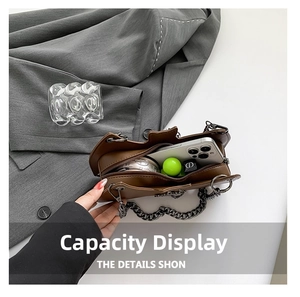 Internal capacity view of brown leather bag showing space for phone and makeup